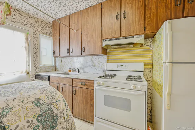 a kitchen with a sink stove and refrigerator