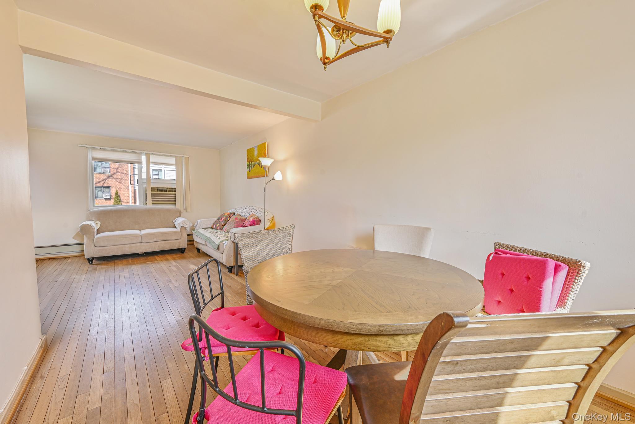 216-06 68th Avenue, Unit 2805 9 Queens, NY 11364 - Photo 5 of 14 a living room with furniture and a wooden floor