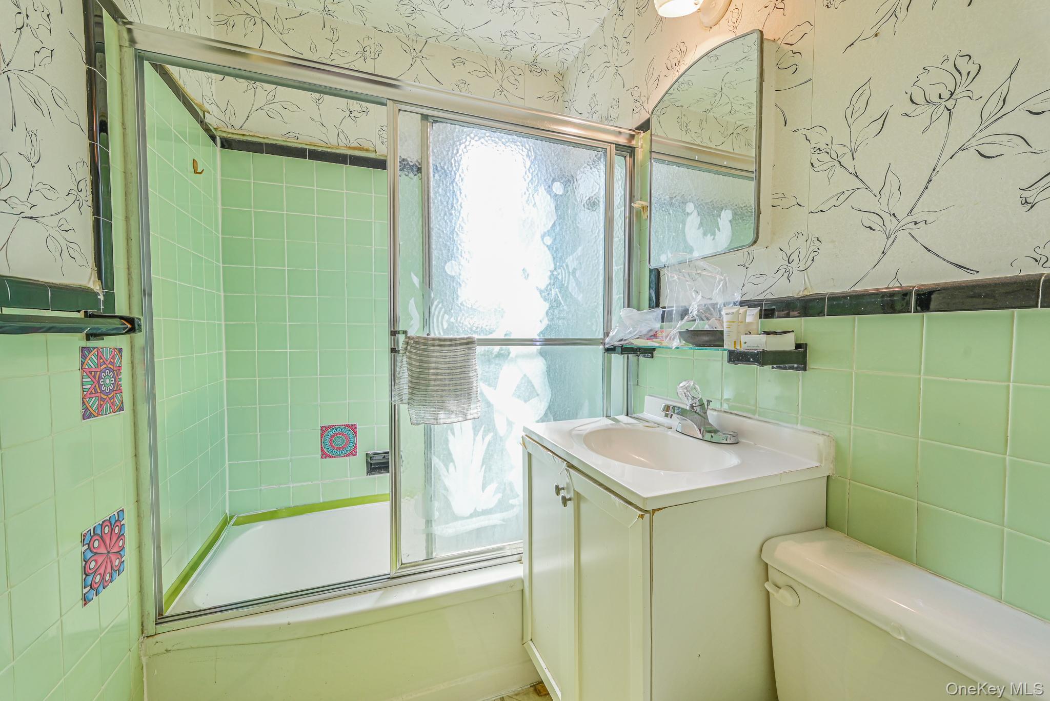 216-06 68th Avenue, Unit 2805 9 Queens, NY 11364 - Photo 8 of 14 a bathroom with a sink toilet and shower