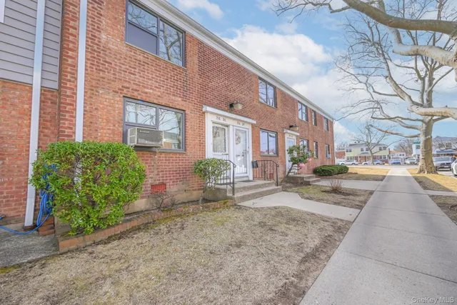 a view of a brick building next to a yard