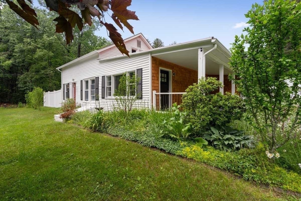 a front view of house with yard and green space