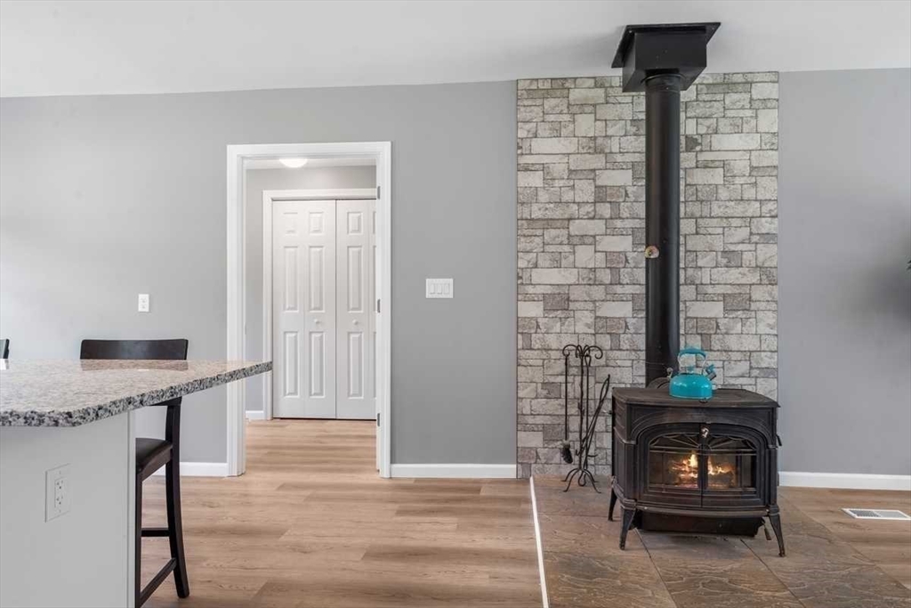 166 Packardville Road Pelham, MA 01002 - Photo 17 of 34 a living room with a fireplace and a wooden floor