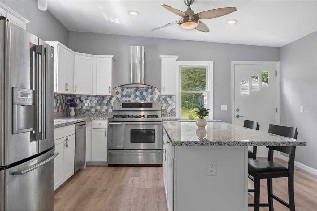 166 Packardville Road Pelham, MA 01002 - Photo 2 of 34 a kitchen with kitchen island a stove a sink and a refrigerator
