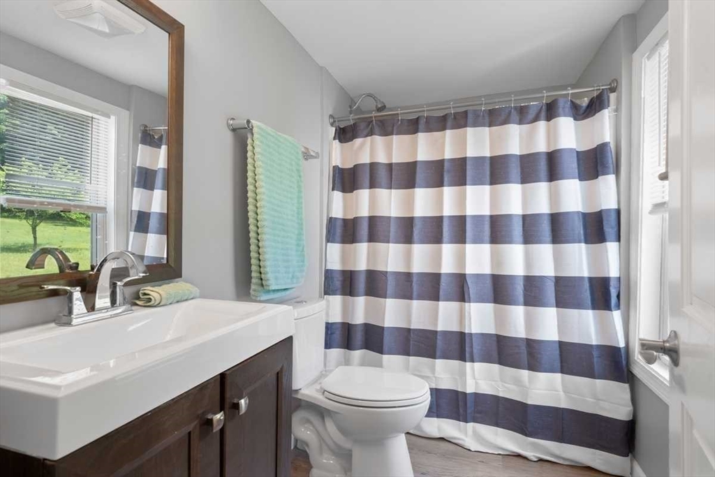 166 Packardville Road Pelham, MA 01002 - Photo 27 of 34 a bathroom with a sink a toilet a mirror and shower curtain