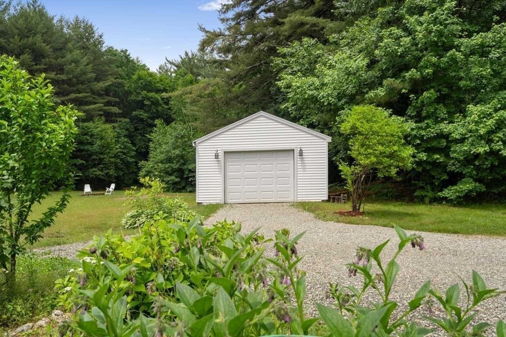 166 Packardville Road Pelham, MA 01002 - Photo 4 of 34 a front view of a house with a yard and garage