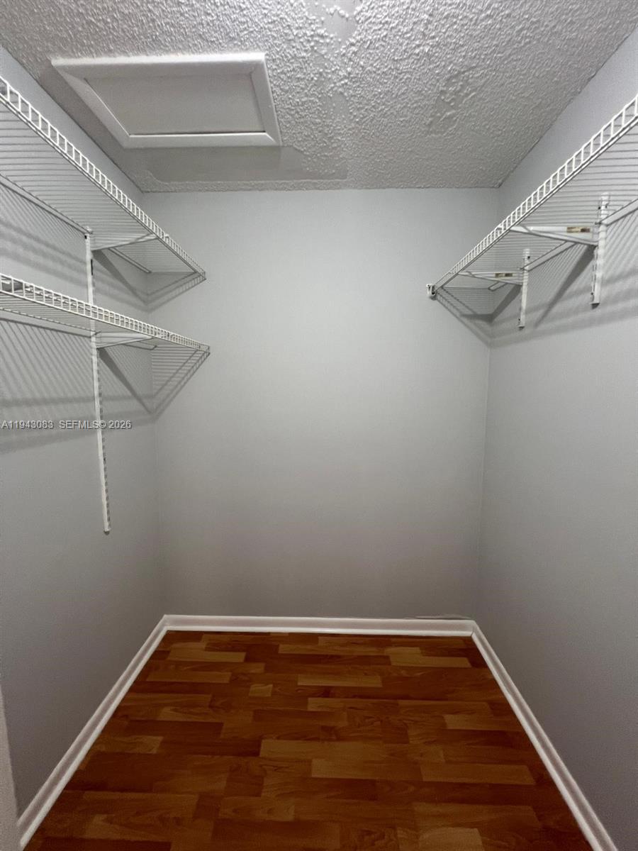 15600 Southwest 80th Street, Unit L302 Miami, FL 33193 - Photo 2 of 16 a view of a room with racks on the wall