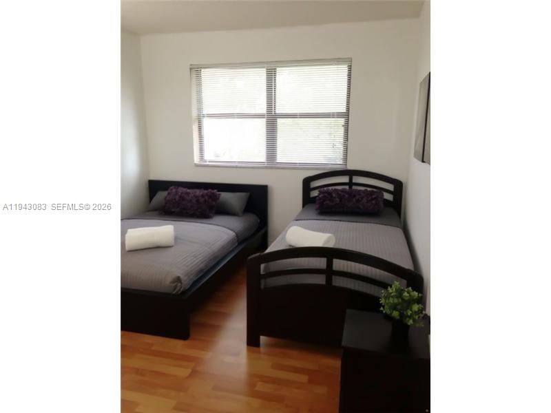 15600 Southwest 80th Street, Unit L302 Miami, FL 33193 - Photo 4 of 16 a bedroom with a bed and a window