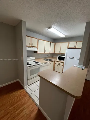 a view of a hallway view with wooden floor and staircase