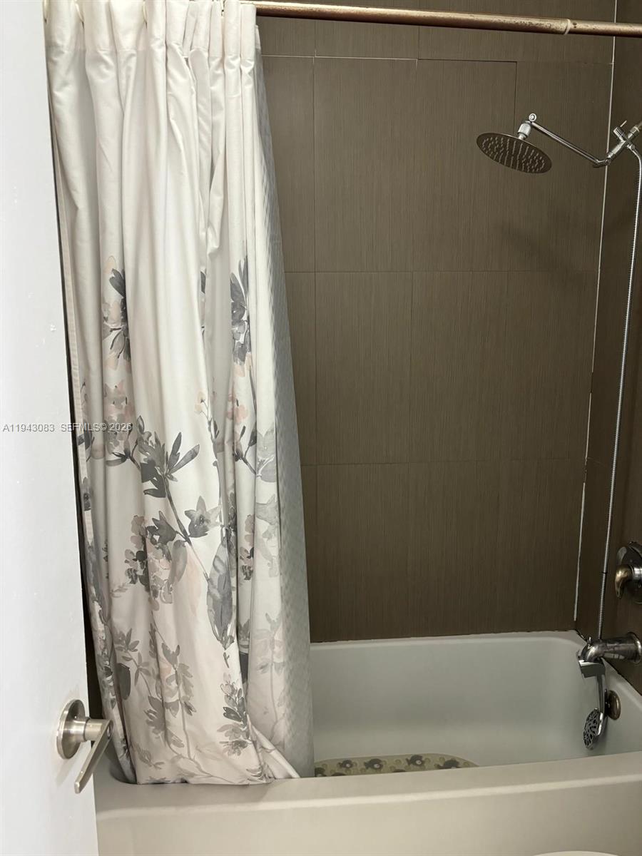15600 Southwest 80th Street, Unit L302 Miami, FL 33193 - Photo 9 of 16 a bathroom with a bathtub and shower