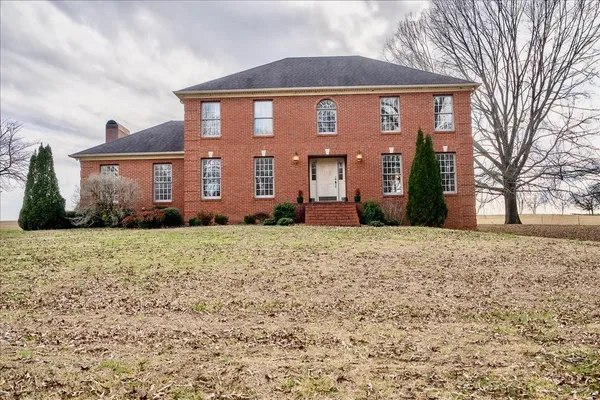 a front view of a house with a yard