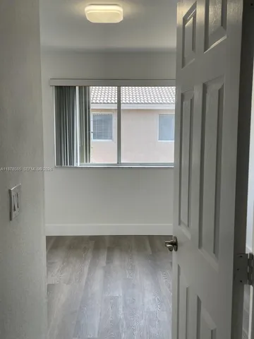 a view of a room that has a large window