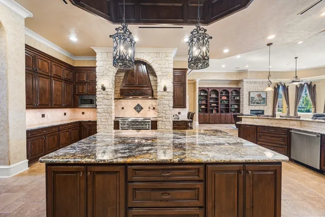 a view of a kitchen with a sink and large window