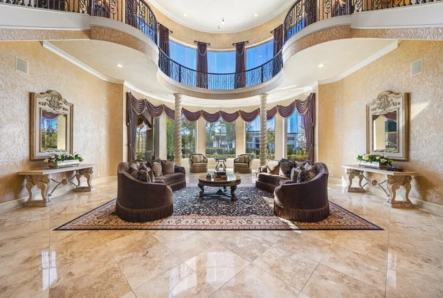 a view of a dining room with furniture a chandelier and wooden floor