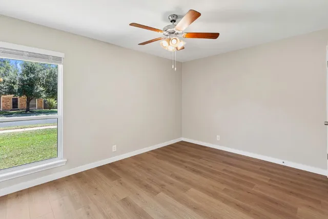 wooden floor in an empty room with a window