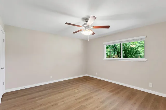 wooden floor in an empty room with a window