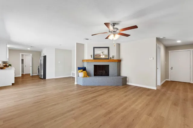 a view of a kitchen with a sink and a chandelier fan