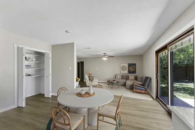 a view of a dining room with furniture and wooden floor