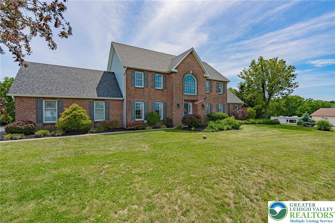 4542 Springfield Drive Coplay, PA 18037 - Photo 3 of 89 Brick facade with striking arched window, this stately residence commands attention.