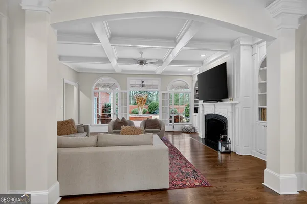 a living room with furniture and large windows