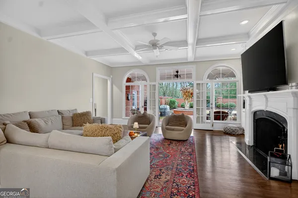 a bedroom with a large bed chandelier and a window