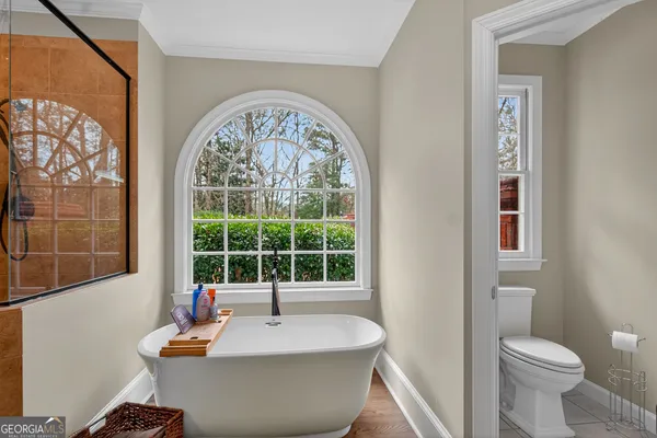 a bathroom with a toilet a sink and a mirror