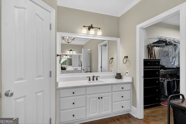 a bedroom with a large bed and a flat tv screen