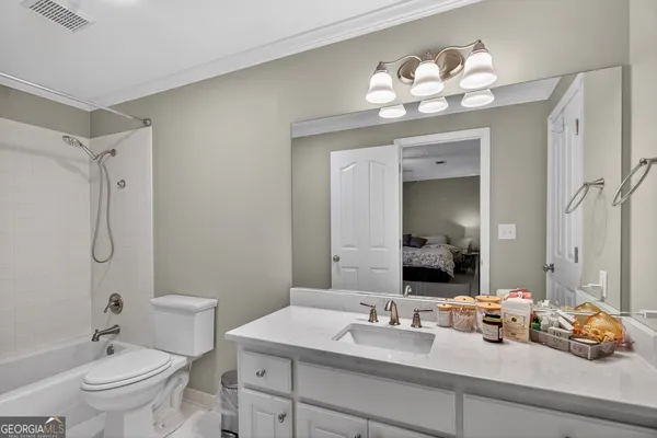 a view of a room with gym equipment and a flat screen tv