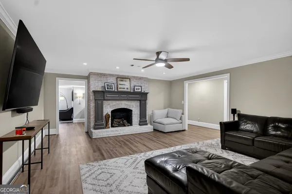 a kitchen that has a lot of cabinets and wooden floor