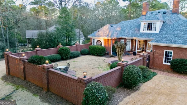a building outdoor space with patio furniture and potted plants