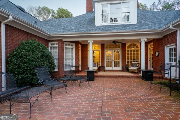 a balcony with furniture and a potted plant