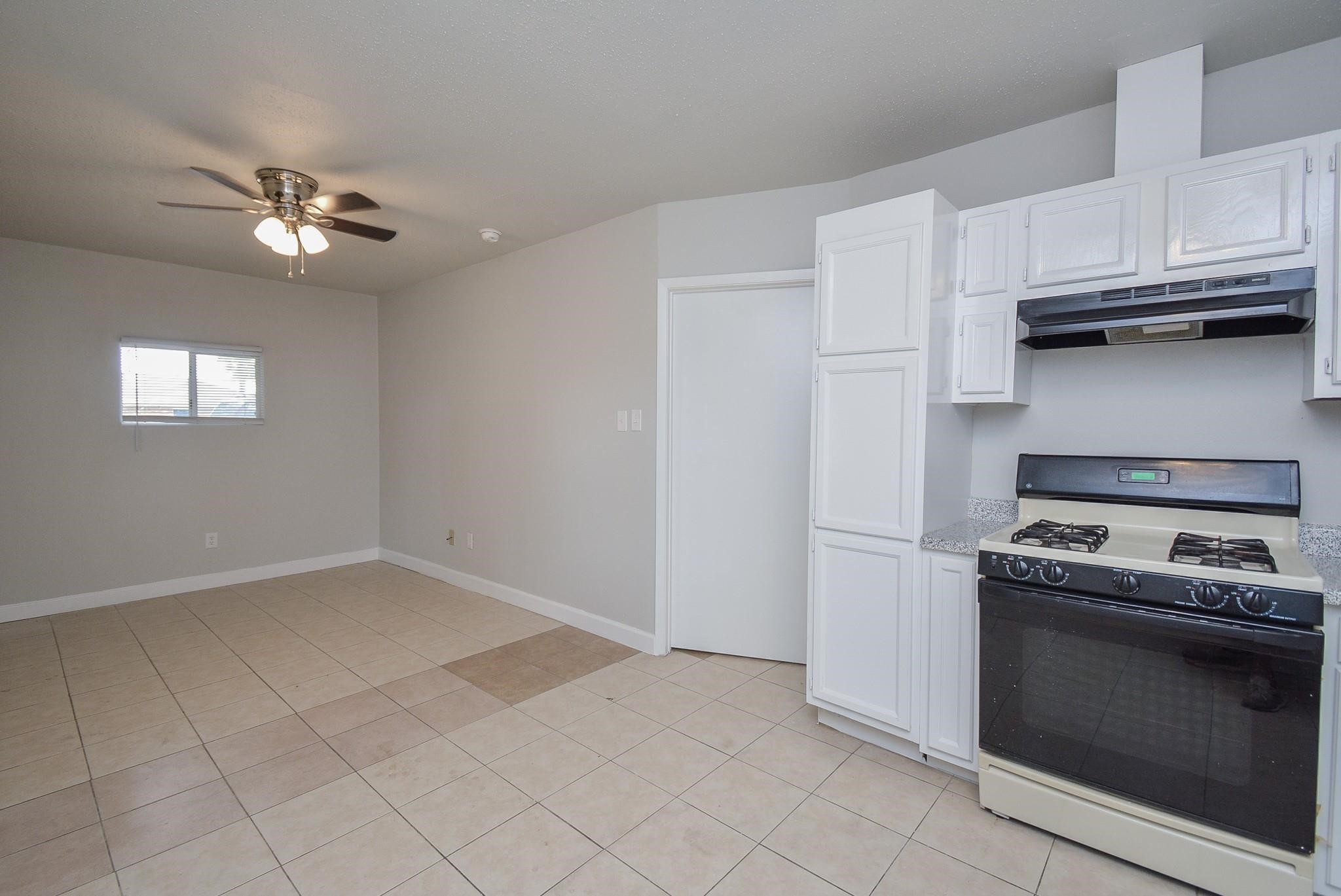 2117 Thonig Road, Unit B Houston, TX 77055 - Photo 11 of 25 a kitchen with white cabinets and appliances