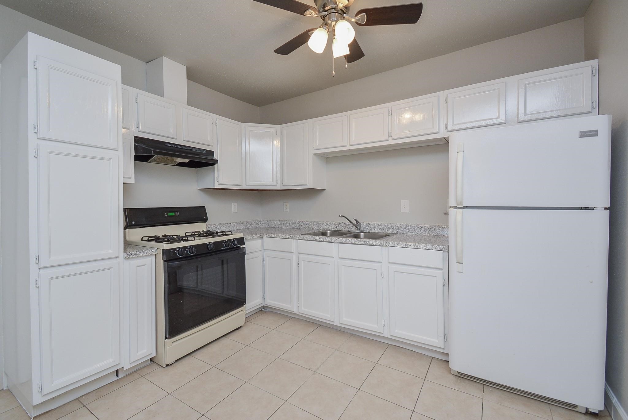2117 Thonig Road, Unit B Houston, TX 77055 - Photo 15 of 25 a kitchen with stainless steel appliances granite countertop a refrigerator sink and stove