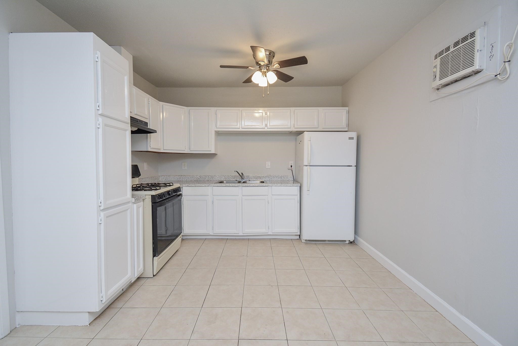 2117 Thonig Road, Unit B Houston, TX 77055 - Photo 16 of 25 a view of kitchen with cabinets and window