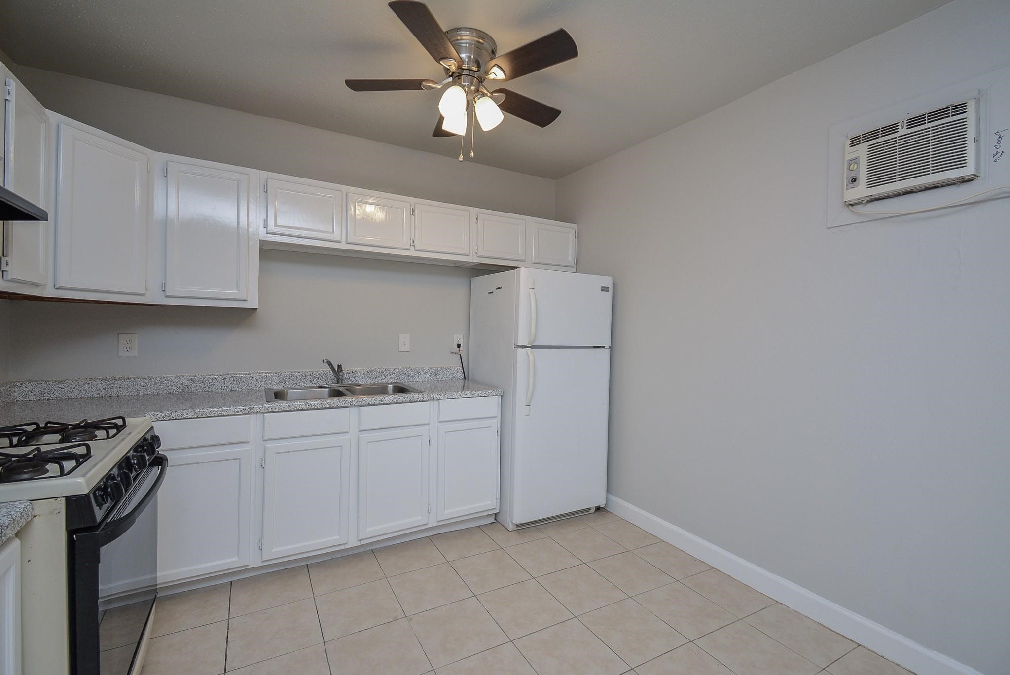 2117 Thonig Road, Unit B Houston, TX 77055 - Photo 18 of 25 a kitchen with a sink cabinets and stainless steel appliances