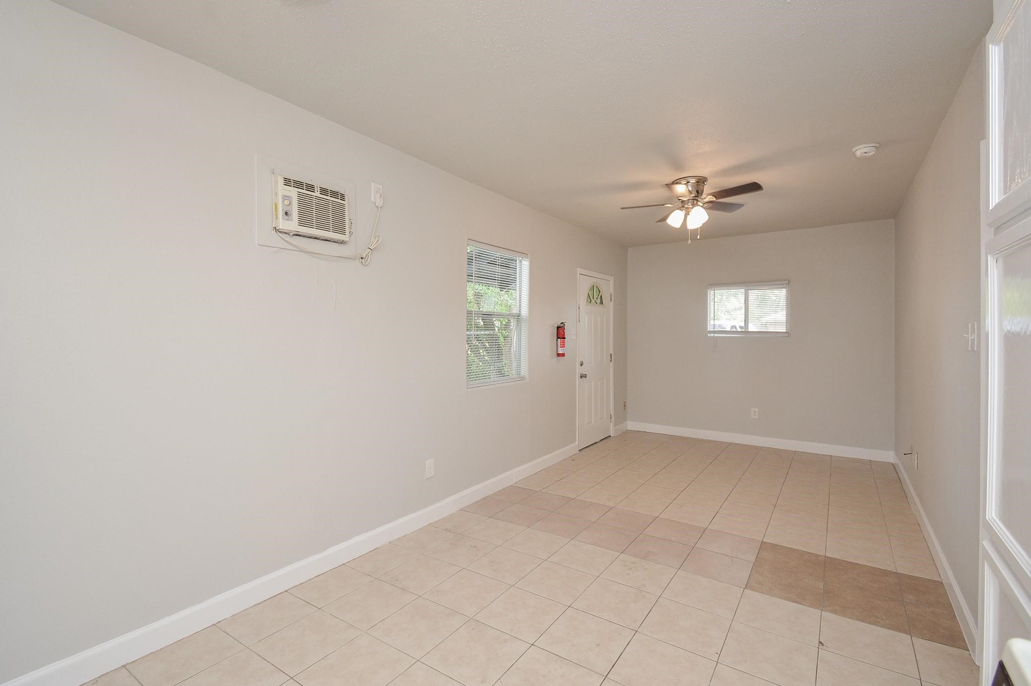 2117 Thonig Road, Unit B Houston, TX 77055 - Photo 20 of 25 an empty room with windows and fan