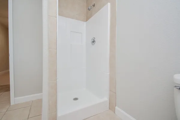 a bathroom with a glass shower door