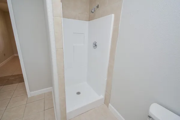 a bathroom with a shower and toilet