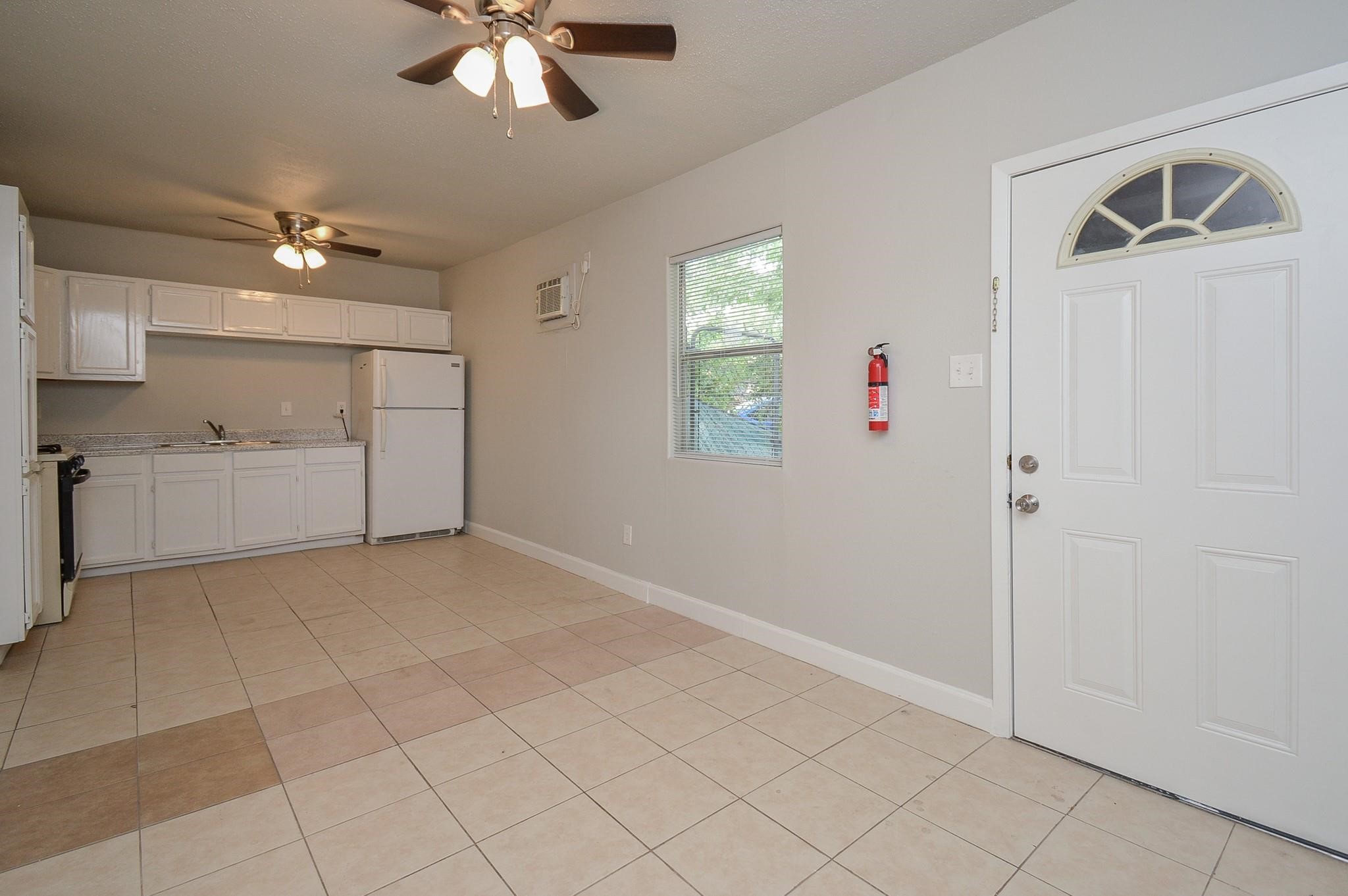 2117 Thonig Road, Unit B Houston, TX 77055 - Photo 4 of 25 wooden floor in an empty room with a window