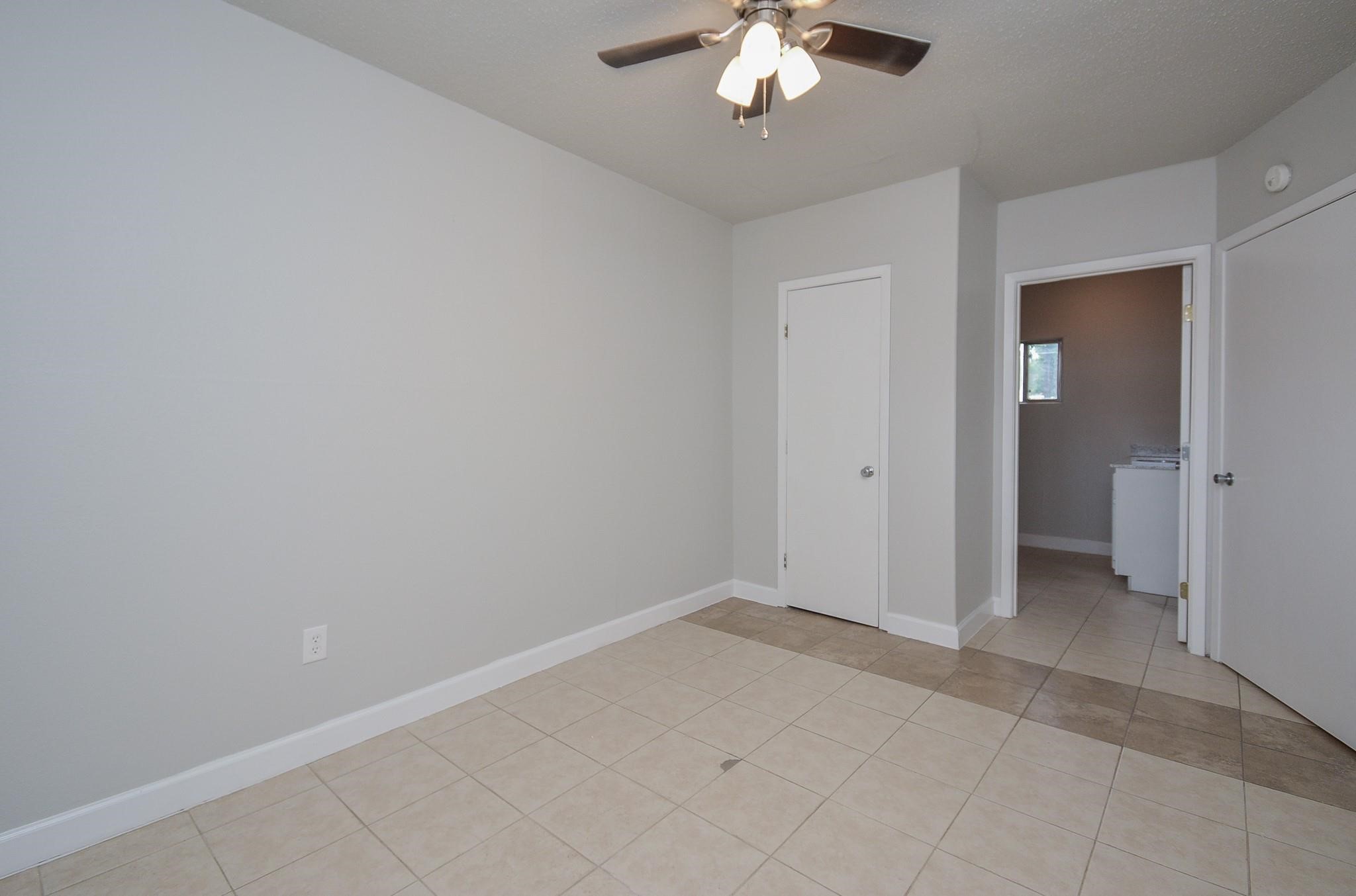 2117 Thonig Road, Unit B Houston, TX 77055 - Photo 5 of 25 an empty room with chandelier fan