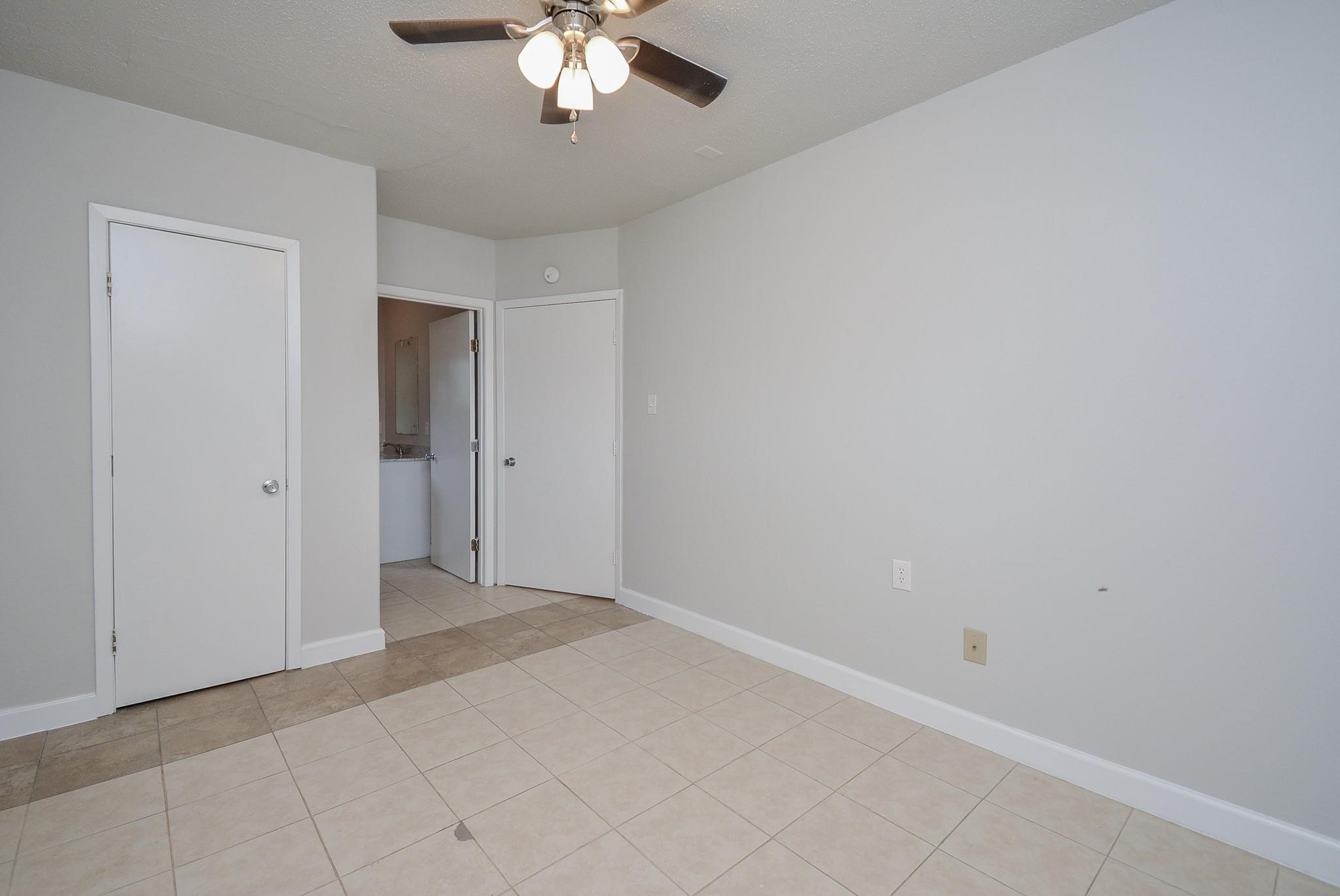 2117 Thonig Road, Unit B Houston, TX 77055 - Photo 6 of 25 a view of an empty room with a chandelier fan