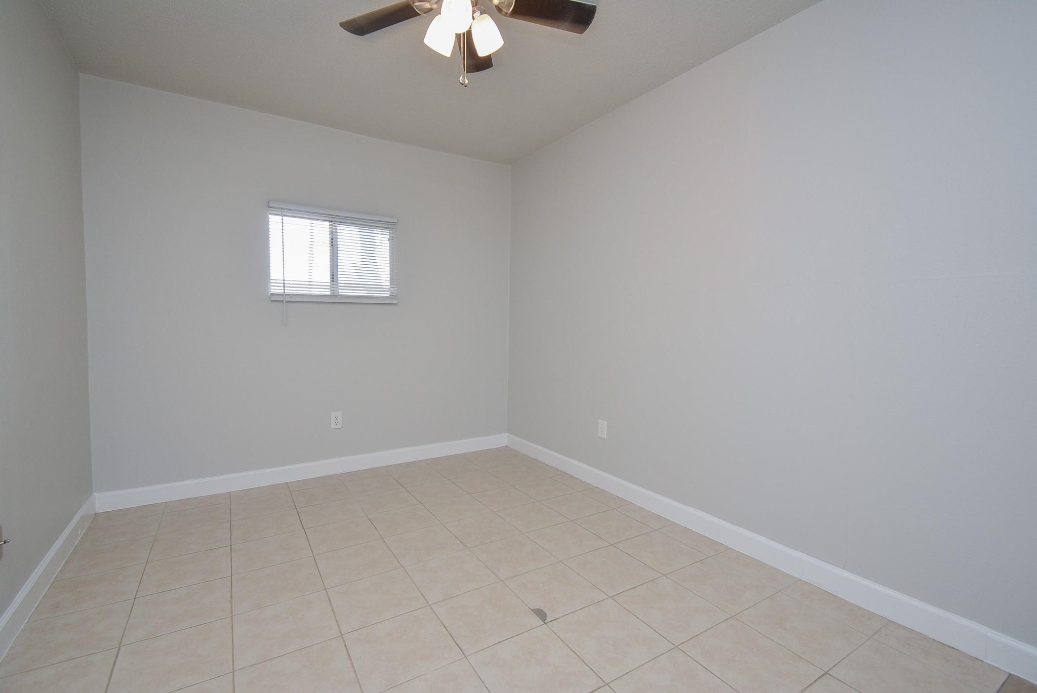 2117 Thonig Road, Unit B Houston, TX 77055 - Photo 8 of 25 an empty room with a chandelier fan