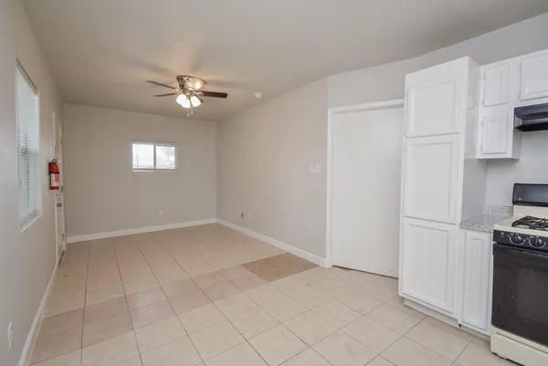 a view of an empty room with a kitchen