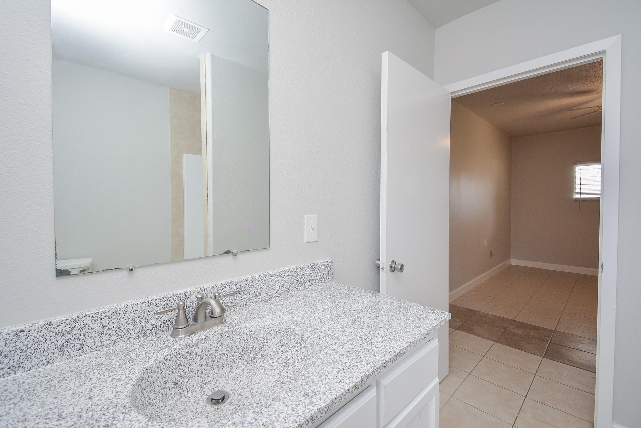 2117 Thonig Road, Unit B Houston, TX 77055 - Photo 10 of 25 a bathroom with a granite countertop sink and mirror