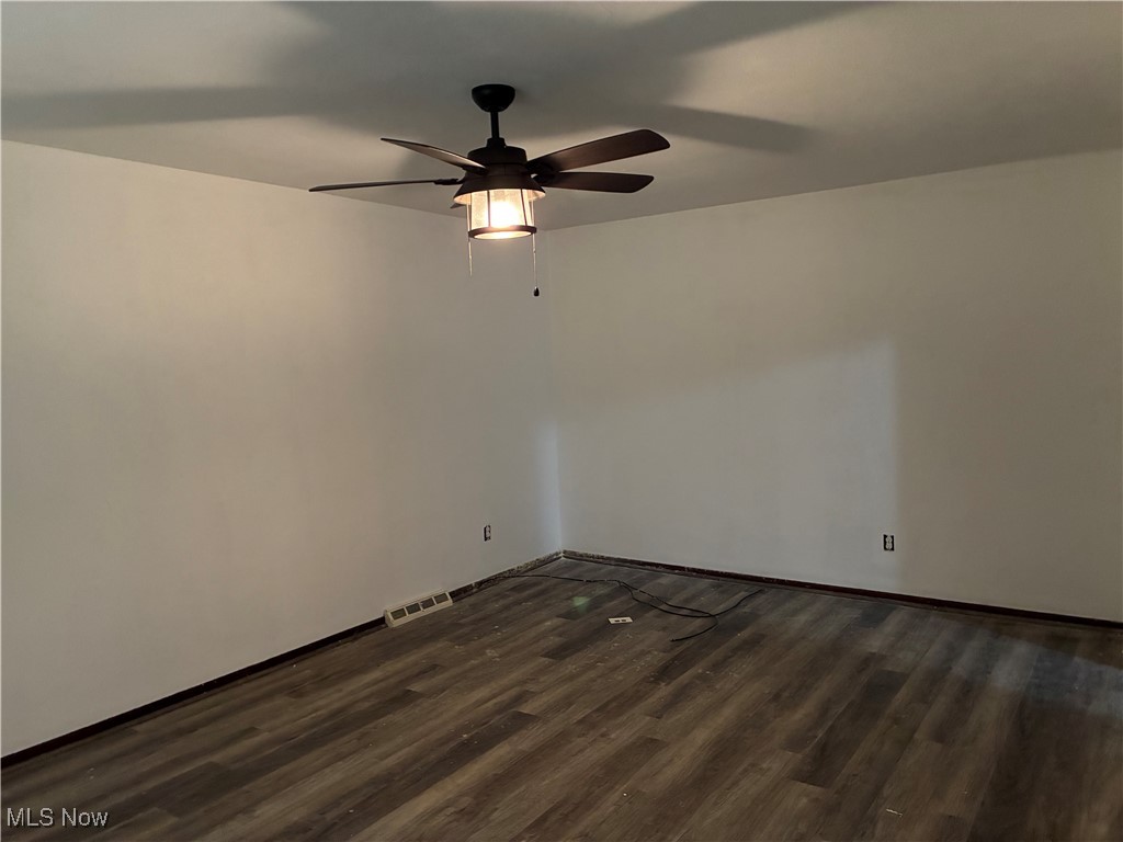 3351-3353 Mayfield Road Cleveland, OH 44118 - Photo 10 of 13 Empty room with dark wood-style floors and ceiling fan