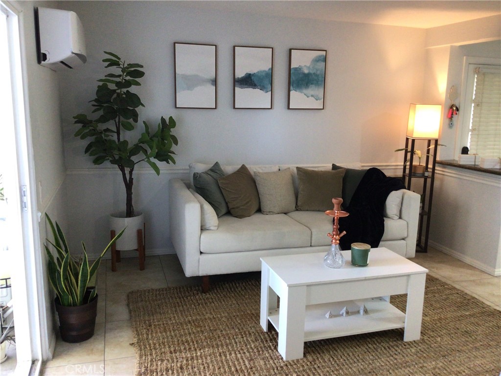 a living room with furniture and a potted plant