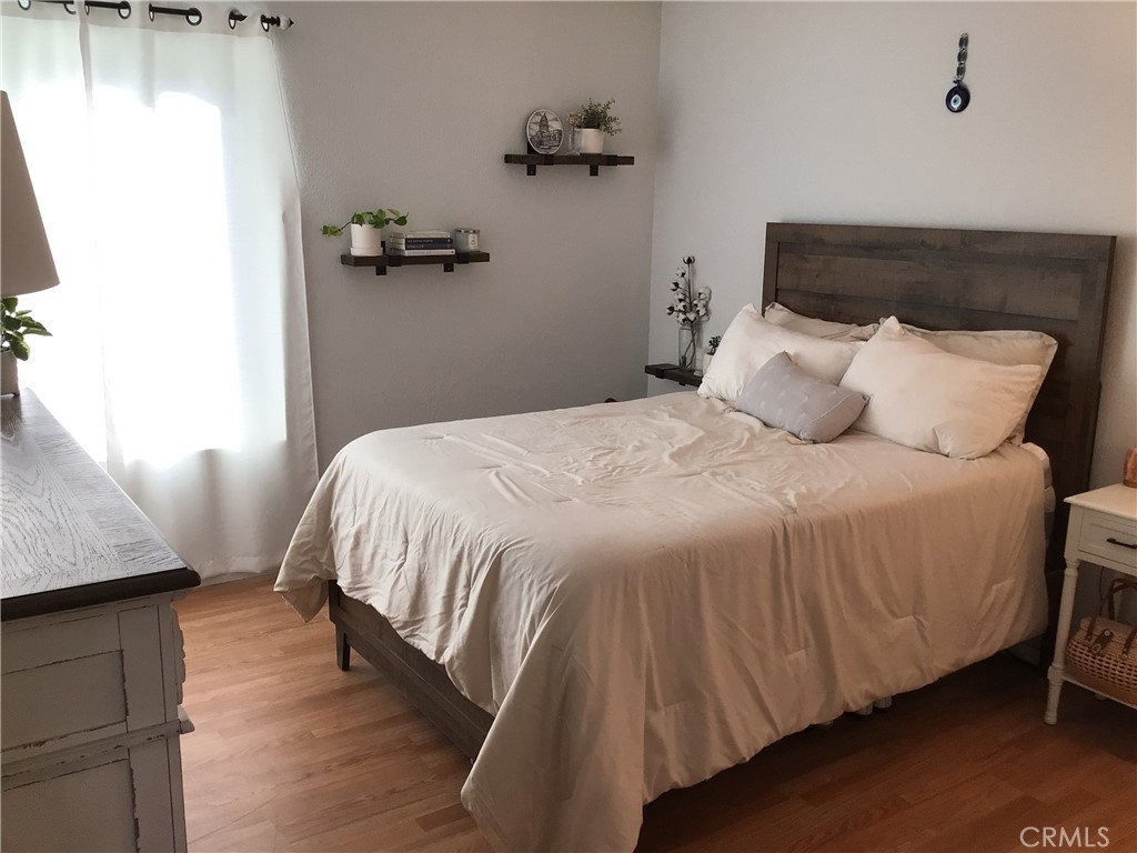 26161-815 Del Rey, Unit C Mission Viejo, CA 92691 - Photo 5 of 11 a bedroom with a bed and wooden floor