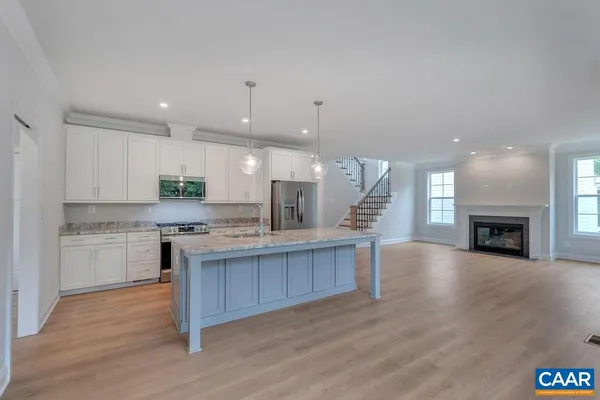 a kitchen with a sink and a hard wood floor
