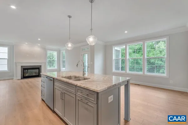 a view of a kitchen with a sink and chandelier