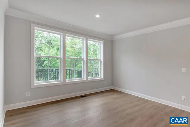 a kitchen with white cabinets and window