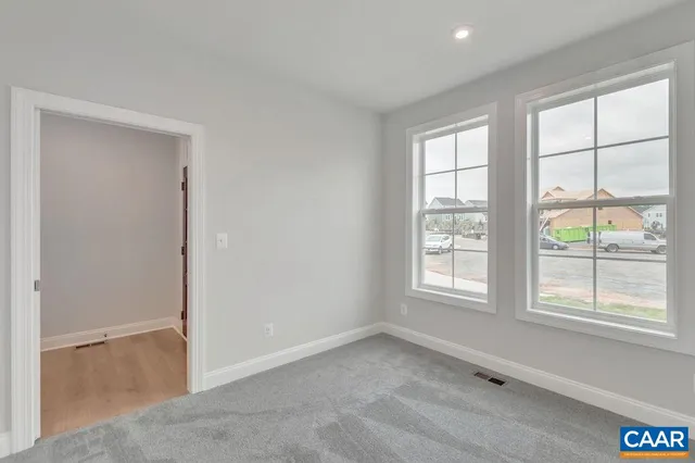 an empty room with windows and closet